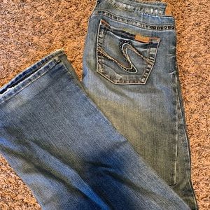 Women’s silver brand jeans with decorative beading around pockets